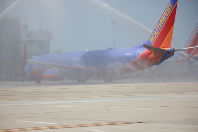 Boeing 737-800 (N8301J) - The first Southwest 737-800 to DIA gets a water cannon salute by Denver Fire as it pulls up to its gate.