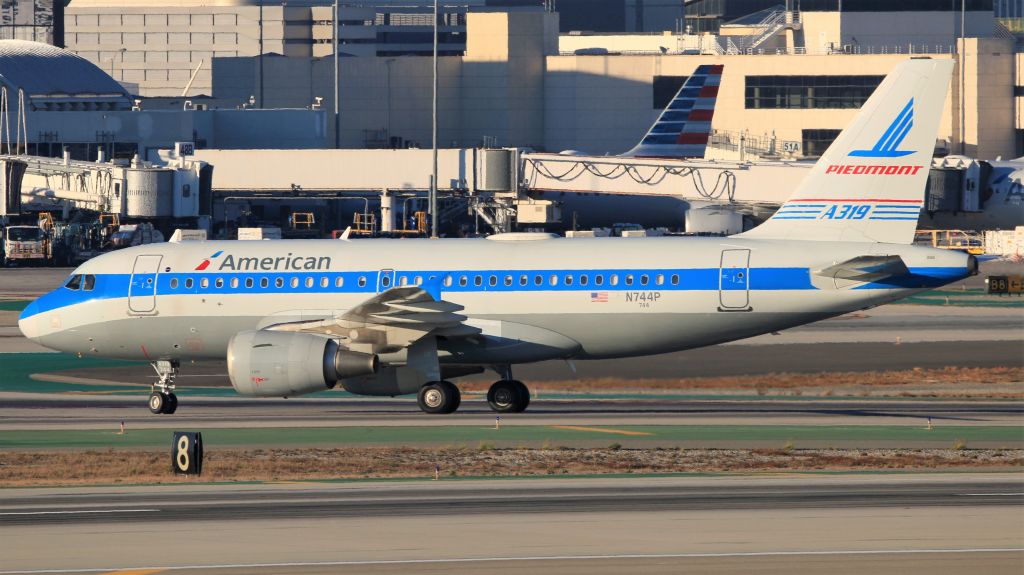 Airbus A319 (N744P) - The American Airlines Piedmont heritage livery, worn by an A319-100, taxis to the terminal after landing at LAX.