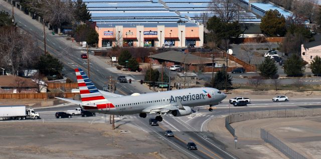 Boeing 737-800 (N200NV) - Looking down from the top of Rattlesnake Mountain as AA's N200NV, a B738, is passing the intersection of Airway Drive and Peckham Lane and is just about to go over RNO's south perimeter fence while on s/final to land on 34L at the end of a DFW-RNO flight.