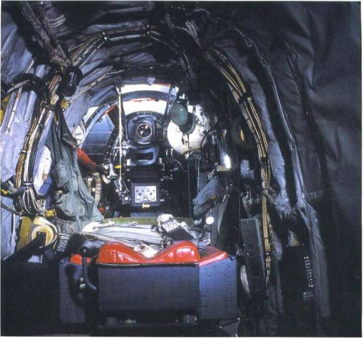 B52D — - B-52D tail gunners position. The seat is folded down flat so the gunner can crawl over the seat. The gunner then raises the seat back and faces to the rear of the aircraft. There is a large canopy over the gunners position.
