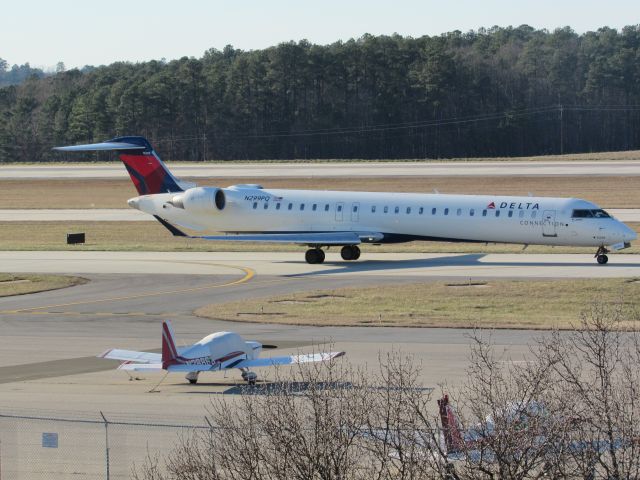 Canadair Regional Jet CRJ-900 (N299PQ) - Delta Connection (Endeavor Air) flight 3719 to La Guardia, a Bombardier CRJ900 taxiing to takeoff on runway 23R. This was taken January 30, 2016 at 4:08 PM.