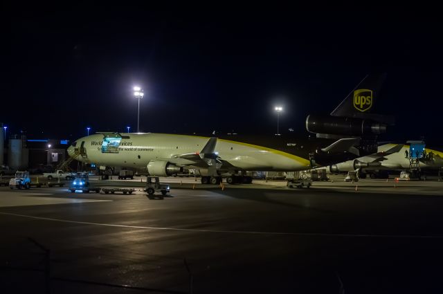 Boeing MD-11 (N271UP) - UPS MD11, N271UP, loads up awaiting an early morning departure from Anchorage (PANC). Seen next to her is Boeing 747-4AF, N570UP. ©Bo Ryan Photography. | a rel=nofollow href=http://www.facebook.com/BoRyanPhotowww.facebook.com/BoRyanPhoto/a Please vote if you like the image!