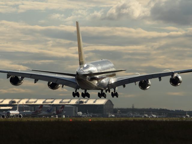 Airbus A380-800 (SV-SKN) - The sun bounces of a rain soaked runway, creating light reflections off the Singapore Airlines A380.