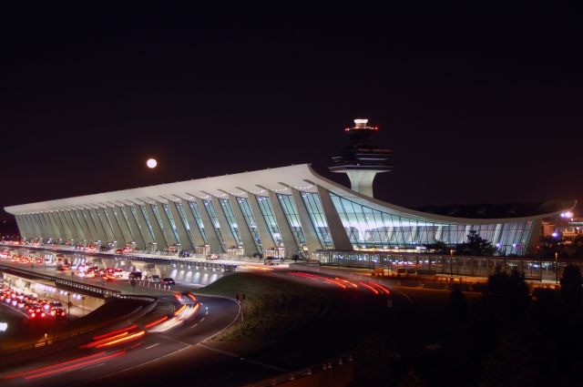 — — - Washington Dulles International Airports main terminal under darkness.