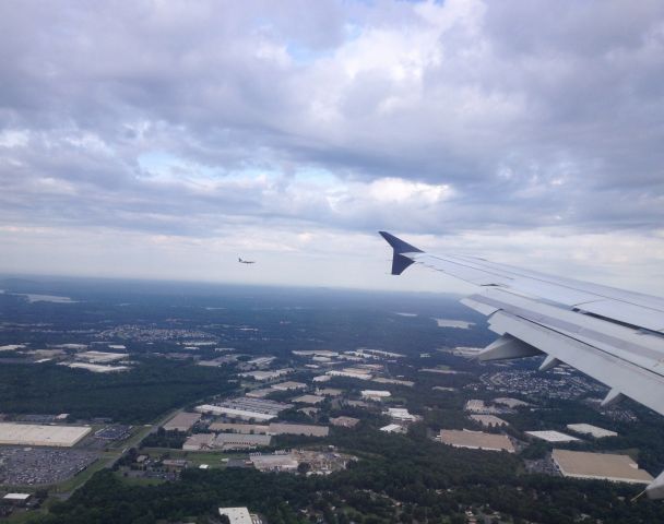 Airbus A321 (N172US) - A US Airways Airbus a321 N172US approching Charlotte Douglas International Airport (KCLT) from Philadelphia International Airport (KPHL) on July 16, 2014. If you look in the background you can see another US Airways plane approching CLT Airport.