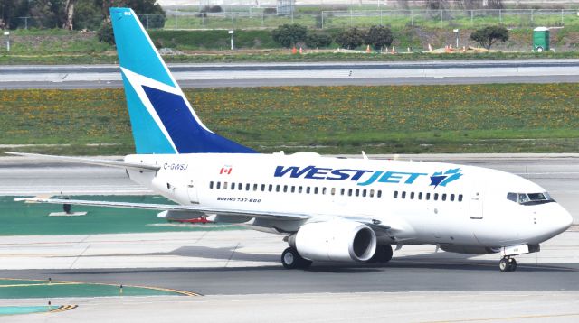 Boeing 737-700 (C-GWSJ) - This picture was taken from the LAX Theme Building.