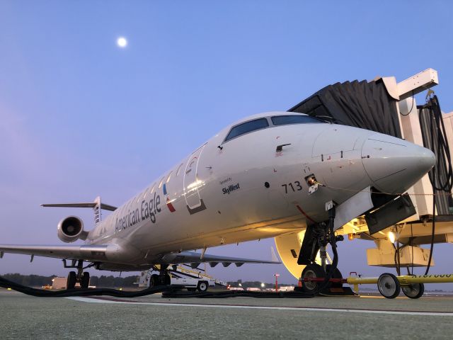 Canadair Regional Jet CRJ-700 (N713SK) - A SkyWest CRJ700 sits under the moon at South Bend before heading out to Dallas Fort Worth