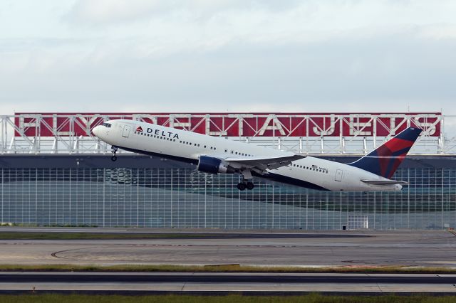 BOEING 767-300 (N140LL) - Departing 8R in front of the new North Glass wall of Deltas recently completed Engine Center. This 767 soon to be retired 