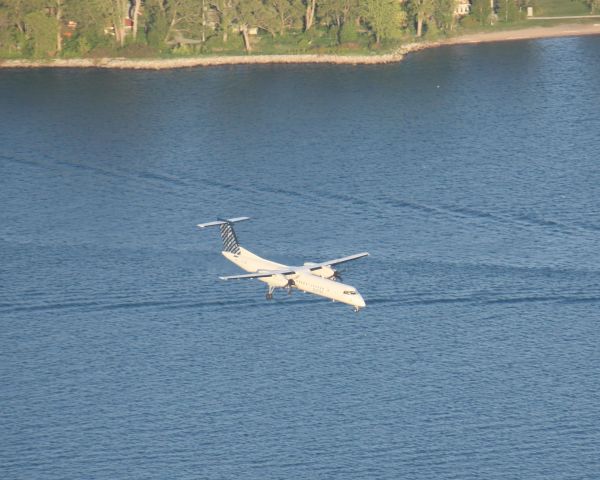 de Havilland Dash 8-400 (C-GLQB) - Taken from the top of CN Tower,Porter Airlines coming in for a landing over east end of Center Island,Landing at Billy Bishop Airport(CYTZ)