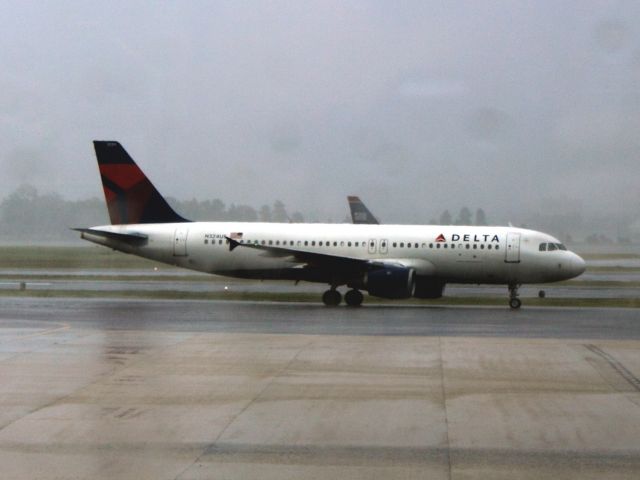 Airbus A320 (N324US) - Sitting in a thunderstorm on the ramp at DCA on 08/07/2011.  No traffic is moving at this time.