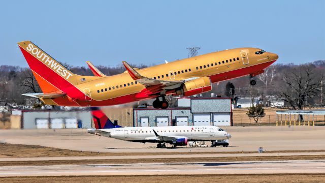 Boeing 737-700 (N711HK) - Southwest Airlines (Classic Retro Livery) taken from airport parking lot as it was departing from runway 5L.