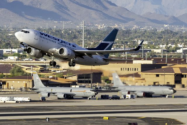 Boeing 737-700 (C-GWSQ) - Taking off with KC-135Rs from the 161st ARW in the background. 