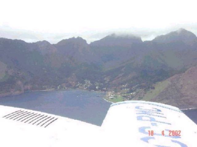 CC-PCN — - Circling Juan Fernández Island (Robinsoe Crusoe) before landing. Only inhabited village visible in bay.