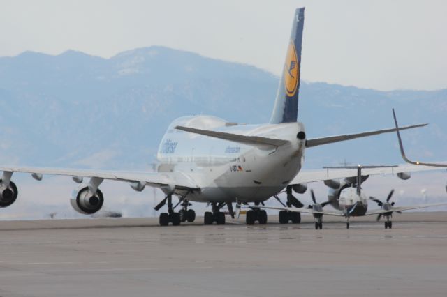 Boeing 747-400 (D-ABTL) - Taxiing to its gate with a Great Lakes Beech 1900 waiting behind.