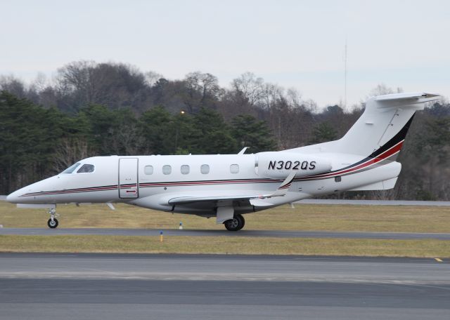 Embraer Phenom 300 (N302QS) - NETJETS taxiing in at KJQF - 12/20/13