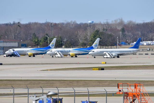 BOEING 737-400 (N313XA) - Not too often you see three 737-400's lined up anywhere anymore, except IND during March Madness. Three variants of livery as well. Apologies for the softness of the photo, was shooting from a distance away, and had heat haze to contend with as well.