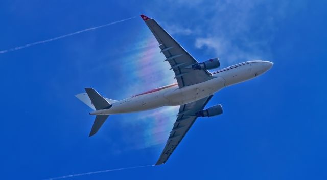 Airbus A330-200 (7T-VJV) - "Rainbow" colored contrails behind the wings of the aircraft.Take-off.