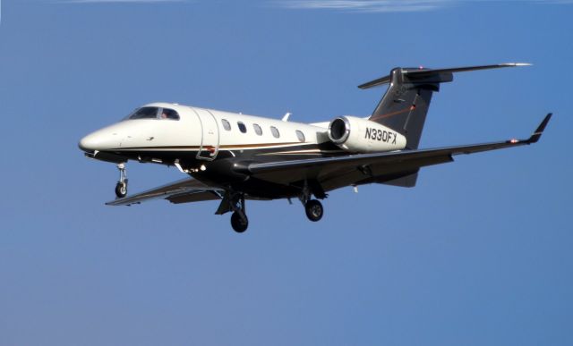 Embraer Phenom 300 (N330FX) - On final is this 2010 Embraer Phenom 300 in the Autumn of 2019. 