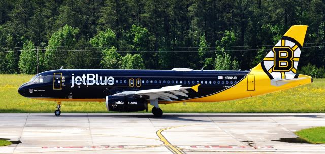 Airbus A320 (N632JB) - The new Bear Force One makes her way to Canes territory, very suspiciously right after she was painted.  I wonder why...! ;) Nothing like fields of dandelions to set off a yellow livery.  From the RDU observation deck, 5/13/19.