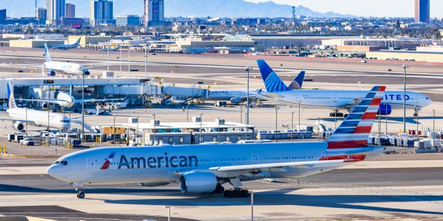 Boeing 777-200 (N776AN) - An American Airlines 777-200 taxiing past two United Airlines 777-200s at PHX on 2/9/23 during the Super Bowl rush. Taken with a Canon R7 and Tamron 70-200 G2 lens.