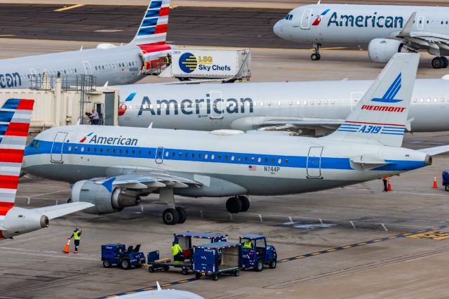 Airbus A319 (N744P) - An American Airlines A319 in Piedmont retro livery taxiing at PHX on 2/13/23, the busiest day in PHX history, during the Super Bowl rush. Taken with a Canon R7 and Canon EF 100-400 II L lens.