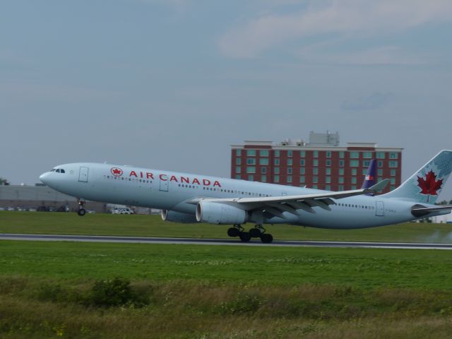 Airbus A330-300 (C-GHKX) - partial touch down,wheels still in the air