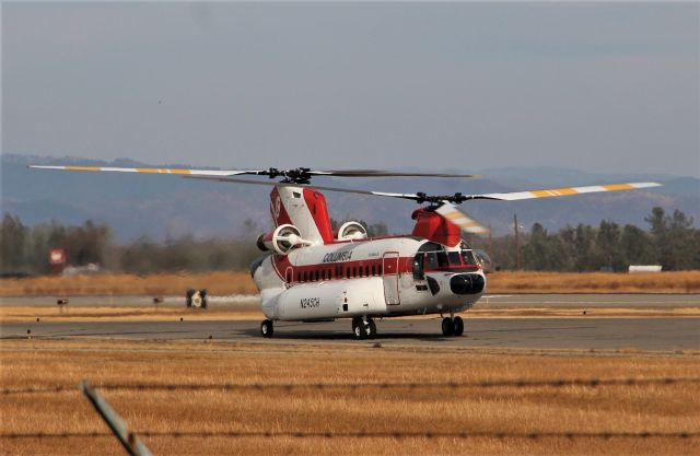 Boeing CH-47 Chinook (N245CH) - KRDD Nov 12 2020 I was parked at lunch and there is usually no air traffic at Redding quite often - I figured most of the Air tankers had finally left for home bases and I was looking north and I saw something spinning like a rotor behind the Civil Air Patrol building by the Canberra. A minute later the Columbia heavy lift Chinook eases out towards the hold bars for departure, and sat for 5 minutes running the jets and high speed rotors. I got out for video as I'd never seen a Columbia Chinook depart. Though they hid behind that one tree at Redding - I was able to get decent video - Im unsure this -47 was headed home, as it is now raining pretty good here so hopefully fire season 2020 is finally over!