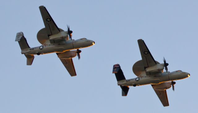 Grumman E-2 Hawkeye (16-8595) - Illuminated by the final few moments of sunlight from the west, a pair of E2D Hawkeyes (168595 and 168592) of VAW-125 (NAS Norfolk - USS Theodore Roosevelt) prepare to break left and come around to land on NAS Fallons runway 31L.