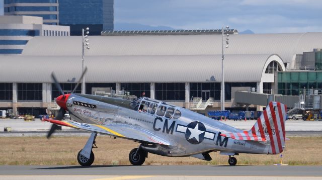 North American P-51 Mustang (NL251MX) - "Betty Jane" taxing past my spotting location on its way to runway 20R. This was the first tour flight for this pilot because when I heard him call the tower on my handheld radio, he asked and they had to tell him the route of flight that the other Collings Foundation aircraft had been using (out over the water and then following the coastline up to Long Beach and then back.