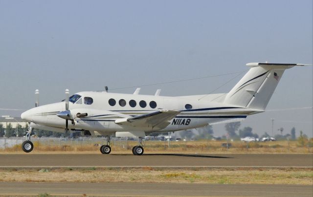 Beechcraft Super King Air 200 (N11AB) - Beechcraft Super King Air 200 lifts off runway one-two at Merced Regional Airport (KMCE)on the first leg of its journey to Brisbane