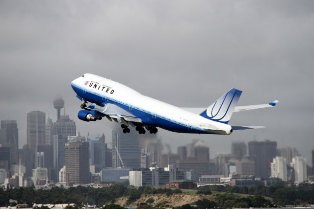 Boeing 747-400 (N120UA) - The tallest buildings in the Sydney skyline are being obscured by clouds as another jumbo takes off.