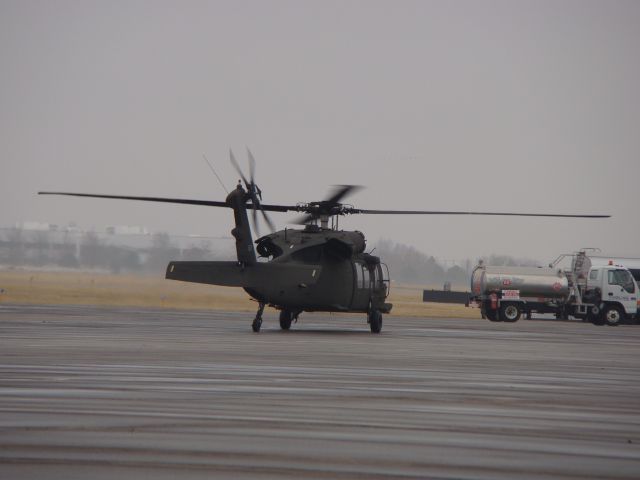 — — - UH-60 Blackhawk taxiing.