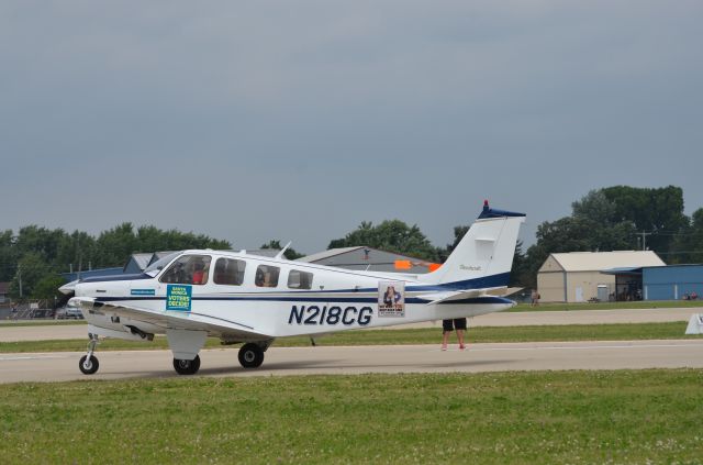 Beechcraft Bonanza (36) (N218CG) - Bonanza mass arrival at AirVenture 2014