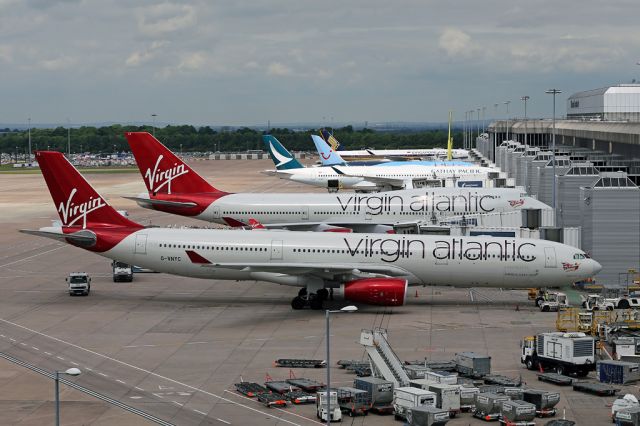 Airbus A330-300 (G-VNYC) - G-VNYC leads the line of aircraft on T2 at Manchester with B-LRI as the first A359 on CPA357/358 from/to Hong Kong and 9V-SMF.