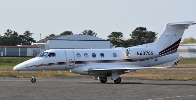 Embraer Phenom 300 (N437QS) - A Netjets Embraer Phenom 300 arrives at the Monmouth Airport, NJ, terminal on an April afternoon, 2021.