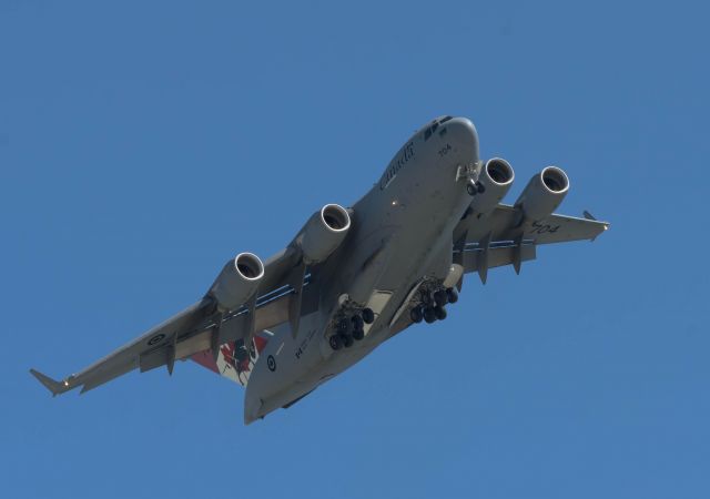 Boeing Globemaster III (17-7704) - Another view of 04 flying overhead.