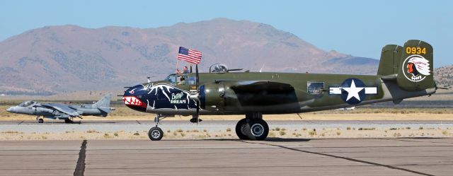 North American TB-25 Mitchell (N5672V) - There is only a 40-year difference in time between these two models of warbirds, but wow! What a difference forty years can make.br /On the left, 163868, a USMC AV-8B Harrier, is just about to take off straight up into the sky as "Bettys Dream" (N5672V; previously 45-8835), a North American B-25J Mitchell bomber operated by the Texas Flying Legends Museum), taxies toward the RTS ramp.br /br /To learn more about "Bettys Dream," click on the link below ....br /br /a rel=nofollow href=http://texasflyinglegends.org/index.php/project/bettys-dream-b-25j-mitchell/http://texasflyinglegends.org/index.php/project/bettys-dream-b-25j-mitchell//a