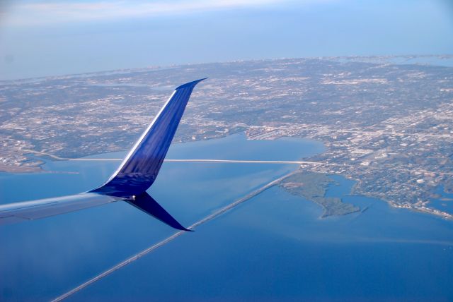 Boeing 737-900 (N877DN) - Flying over Tampa Bay.