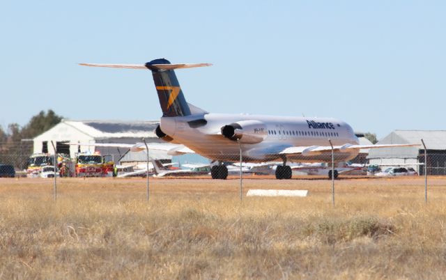 Fokker 100 (VH-UQC) - VH-UQC makes an emergency landing at Longreach Airport just after midday on the 16th July 2018 and is greeted by the emergency services.