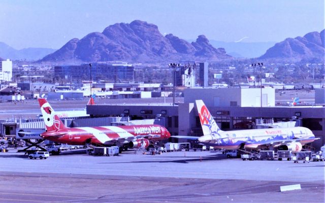 Boeing 757-200 (N902AW) - KPHX - date apprx 1998 shows 2 America West Airlines Logojets (L) N908AW Arizona Cardinals and (R) Coast to Coast Boeing 757s side by side at the gate. If you've never been to Phoenix November to April 1st is a good time to go and use the parking structures to photograph from the top floors if not to hot. April to October way cheaper prices can be found at most Hotels as it is so hot, many people do not travel to this area in the summer, but you can fins great deals if you do travel here in the summer.