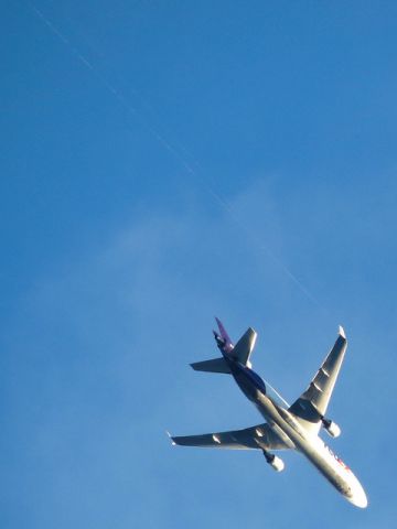 Boeing MD-11 — - After departing from San Diego, this heavy Mad-dog is at about 12,000 ft. and creating some interesting vortexes with its winglets.