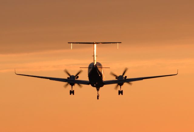 Beechcraft 1900 (C-FEVA) - Flying into the sunset off runway 31 at Gander, Canada.