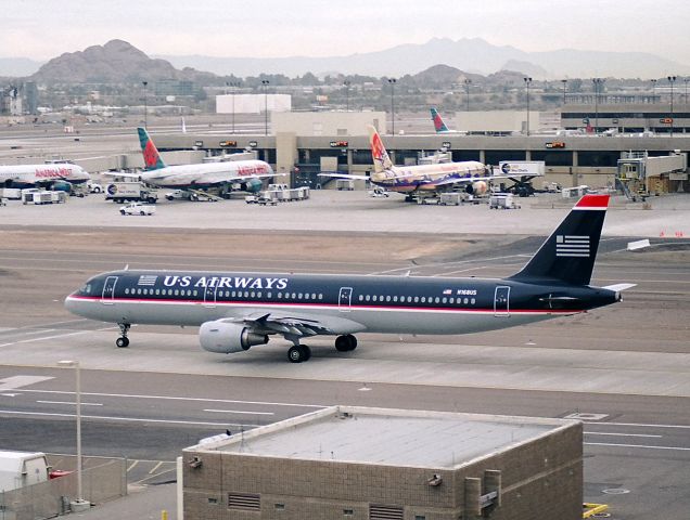 Airbus A321 (N168US) - KPHX - 1-3-2005 - Now long gone US Airways A321 (2015) Taxis past the America West docks in Winter 2005.