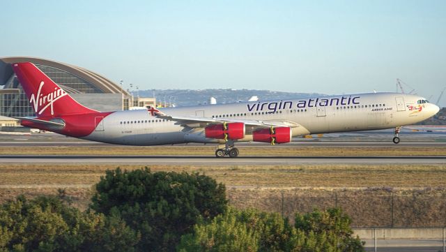 Airbus A340-300 (G-VSUN) - Virgin Atlantic holding a very long flare down 24R at KLAX after a long haul from LHR 