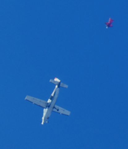 Cessna Caravan (N626LM) - Shown here is a 1998 Cessna 208B Grand Caravan around 13K-14K feet and one of the Skydive Sussex Skydivers departure in the Autumn of 2024. Appears that is all atmosphere that prevents a sharp Picture. 