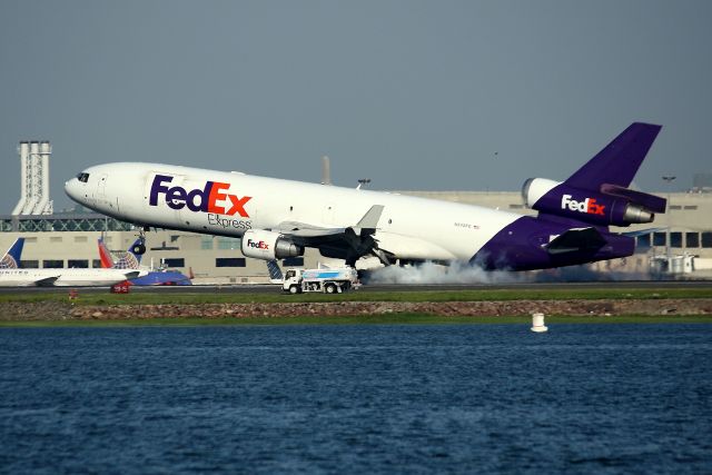 Boeing MD-11 (N642FE) - FedEx 1406 Heavy from Memphis smoking the tires on 22L.