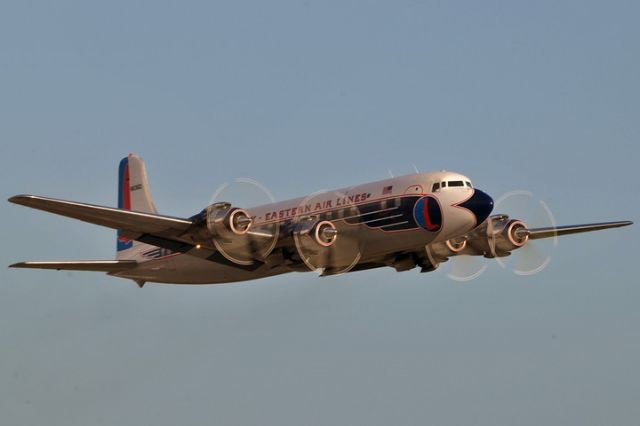 N836D — - Historical Flight Foundations restored Eastern Air Lines DC-7B taking off from its home base at Opa-locka Executive Airport enroute to the EAA AirVenture at Oshkosh with passengers.  This was the 4th flight since the almost six year restoration was completed.  AviationStockPhotos.com