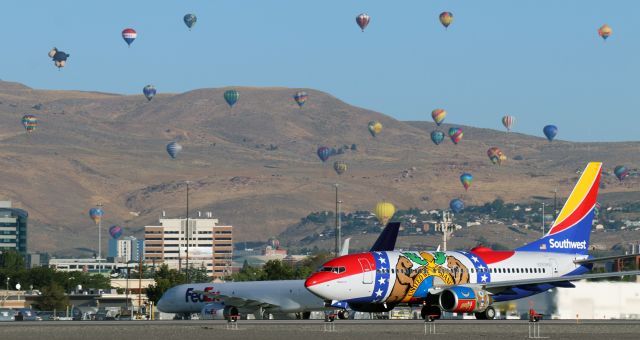 Boeing 737-700 (N280WN) - Morning departure .... SWA's "Missouri One" (N280WN) gains speed down Runway 17R on its "D" roll for a flight to KDEN while the passengers on the starboard side get a fine view of the hot air balloon "Mass Ascension" on the final morning of the annual balloon races.