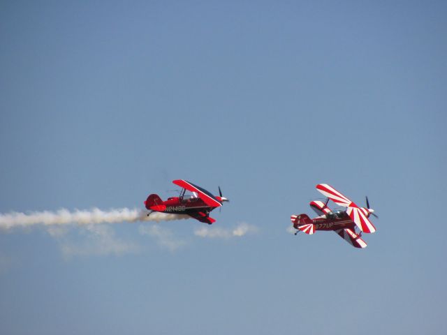 — — - Stunt planes preforming during an airshow at Scott City, KS