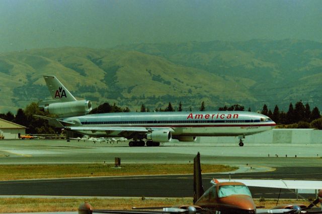 Boeing MD-11 (N1751A) - KSJC - Early 1990s shows American Airlines MD-11 N1751A *48420/451* at the hold bars at 30L for Tokyo-Narita for the apprx 1:00pm PST flight. Many times the NRT flight would sit here on the pad with engines turning for 30 minutes- only to go back to the gate and leave later. I never knew why - this all pre Internet days. photo from the old San Jose State Aviation School parking lot - I had an 8ft ladder in the back of my pickup truck to clear the fence line and GA planes parked in the foreground. N1751A was sold to FedEx in 1996 and this jet was converted to a freighter and still flying as such.